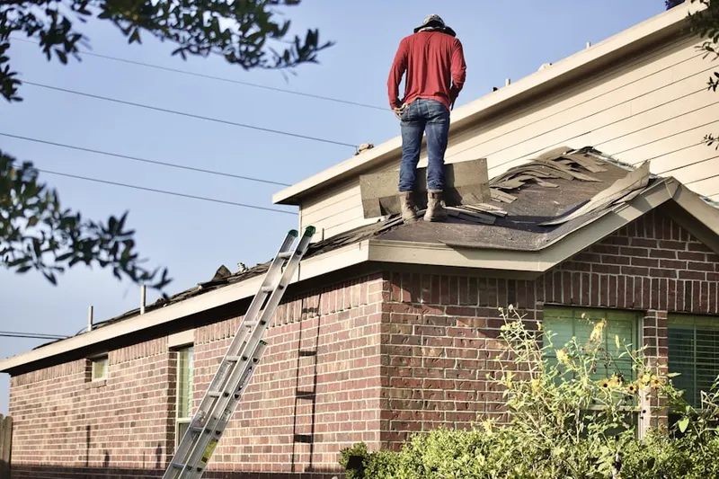 Professional roofer working on a residential roof in West York